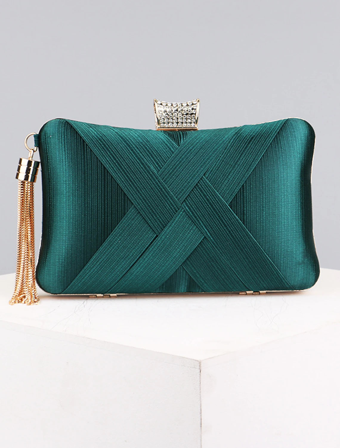 Silk wristlet clutch bag for women, held by hand.
