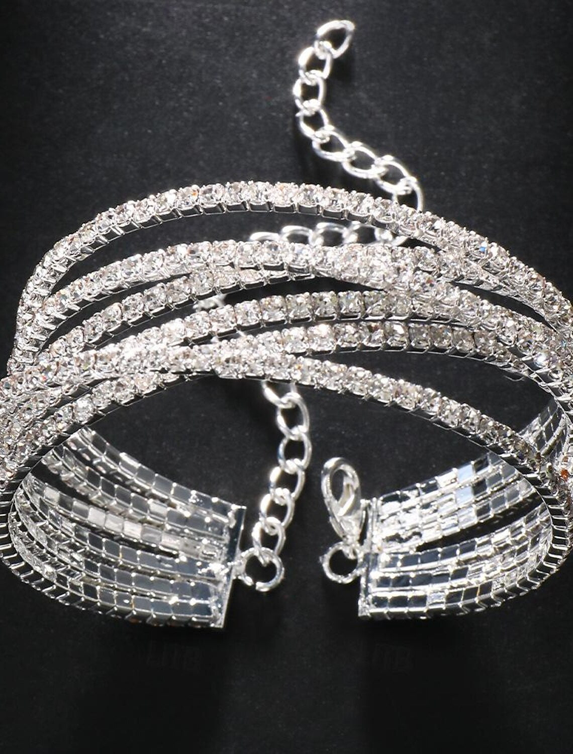 Close-up of a woman's wrist wearing the sparkling silver rhinestone tennis bracelet.