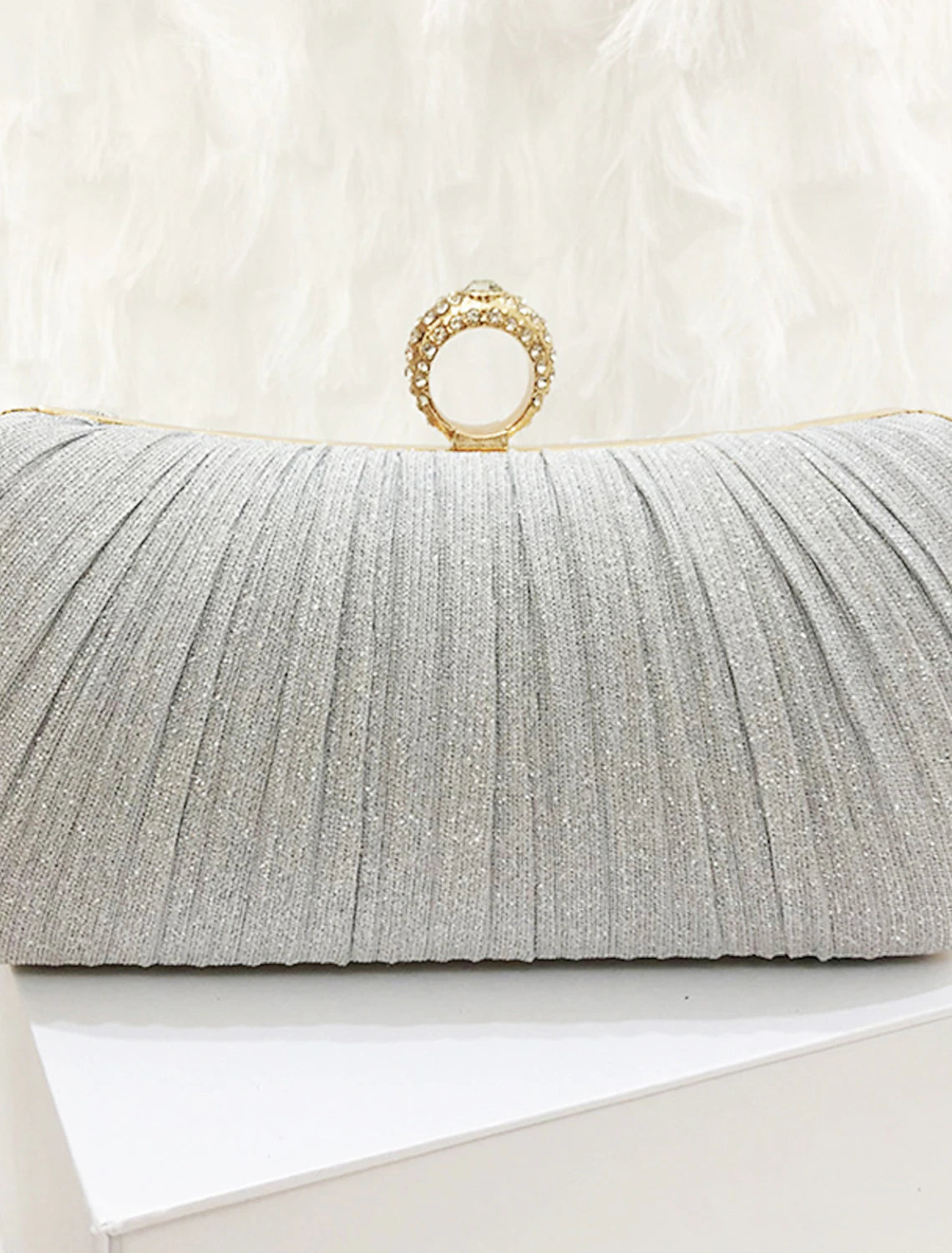 Close-up of a women's synthetic clutch bag, showcasing its texture and solid color.