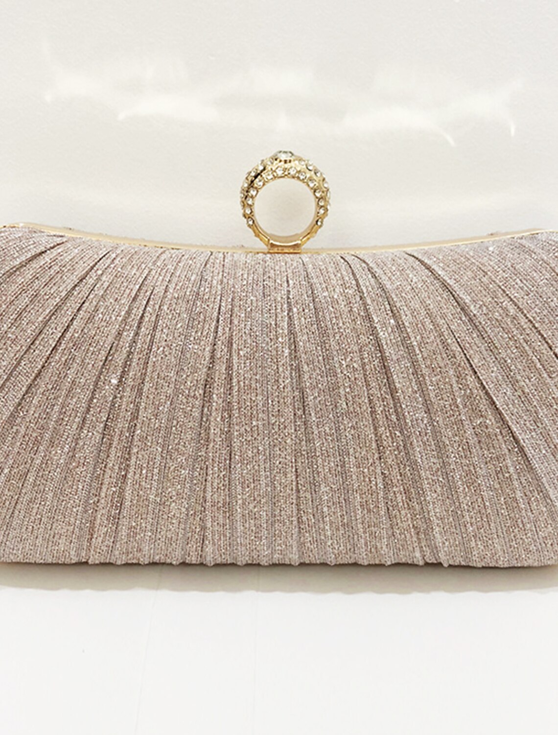 Women's clutch evening bag with a metallic chain, suitable for formal events.