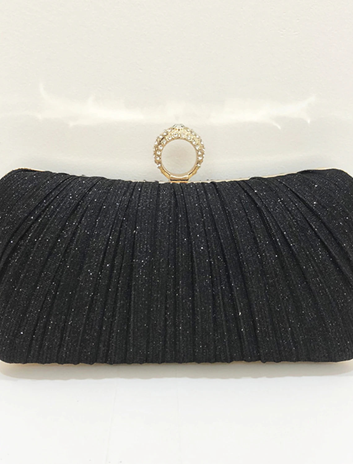 Front view of a solid color synthetic clutch bag for women.