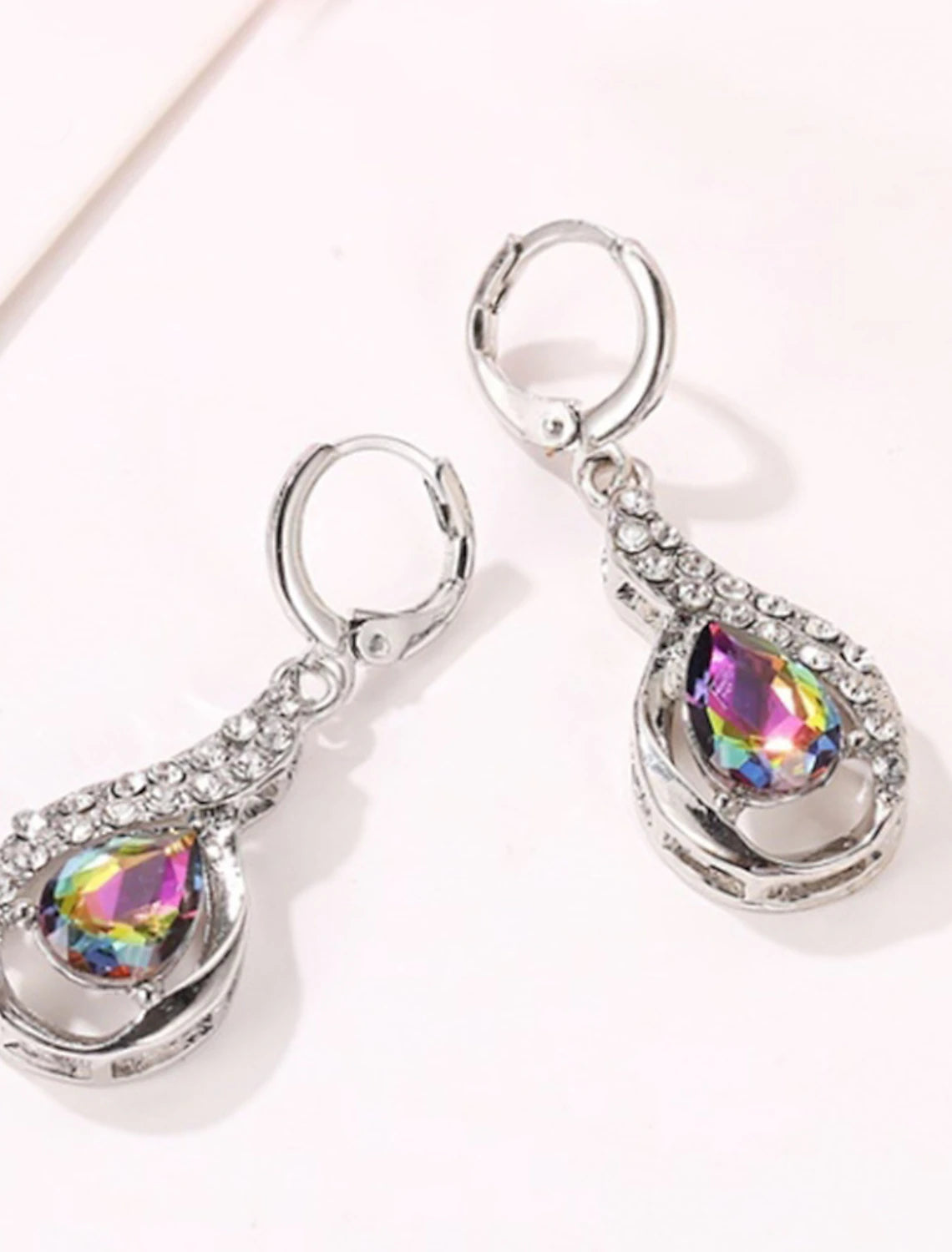 Gold-tone zircon drop earrings with white stones.
