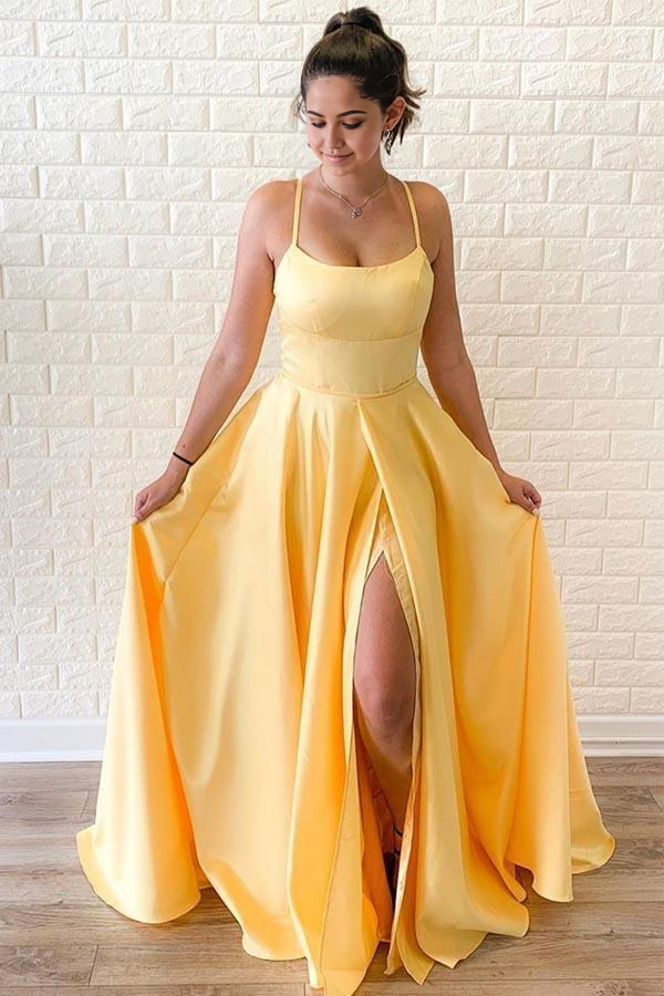 Yellow satin two-piece A-line prom dress with criss-cross straps and a slit.