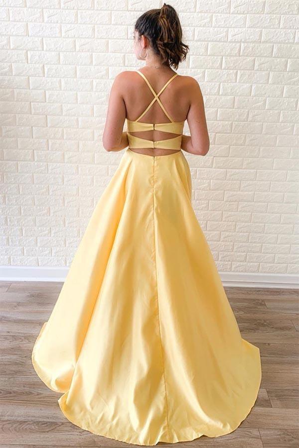 Back view of yellow satin two-piece prom dress showing criss-cross straps.