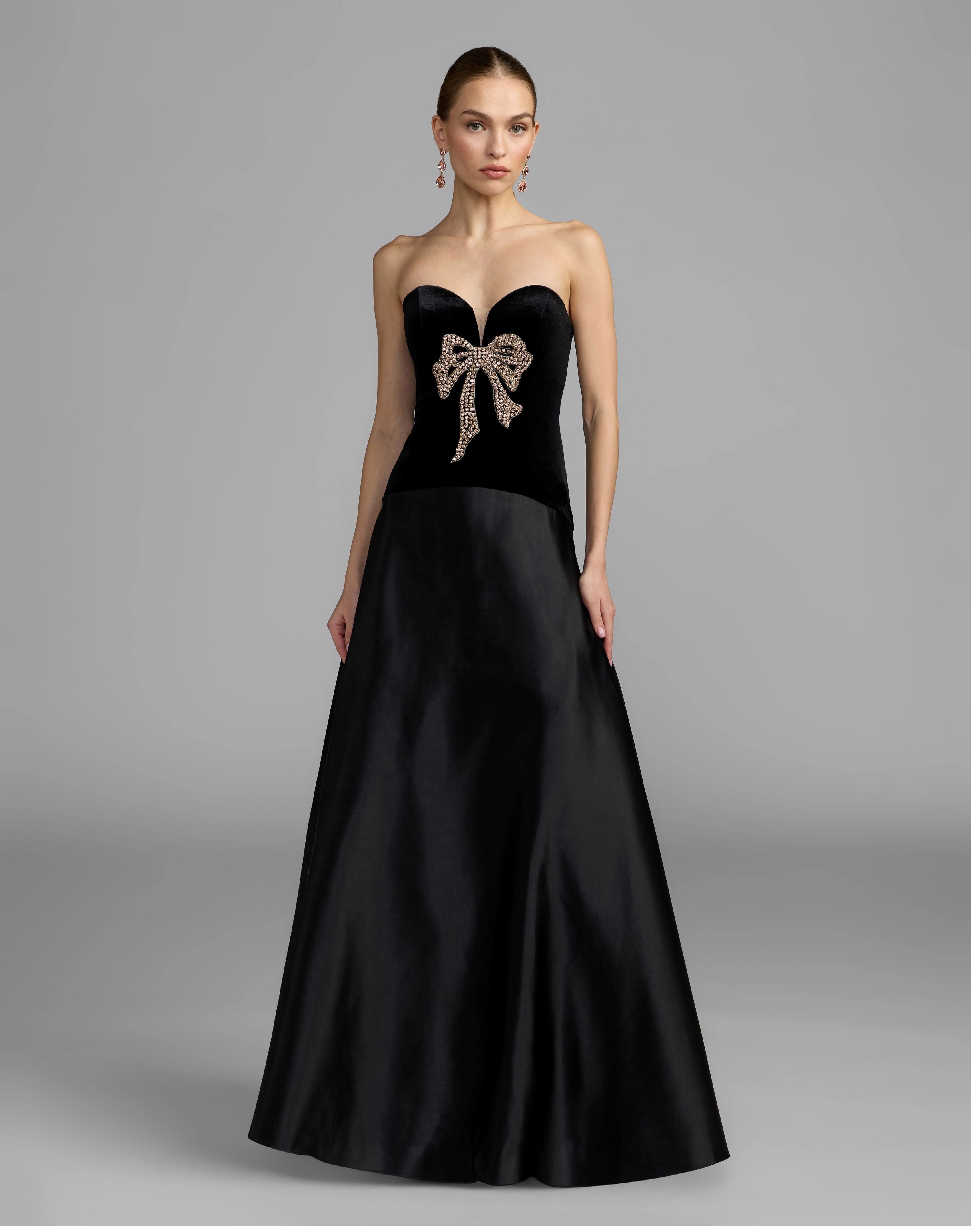 Black strapless velvet beaded bow A line prom gown