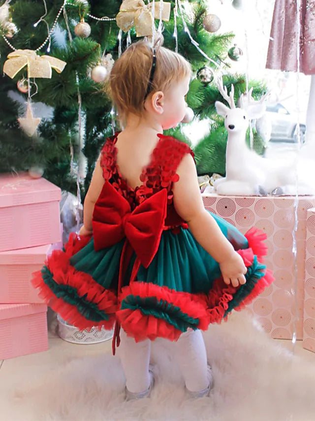 Side view of the elegant tulle flower girl dress, featuring a jewel neck and decorative bows.