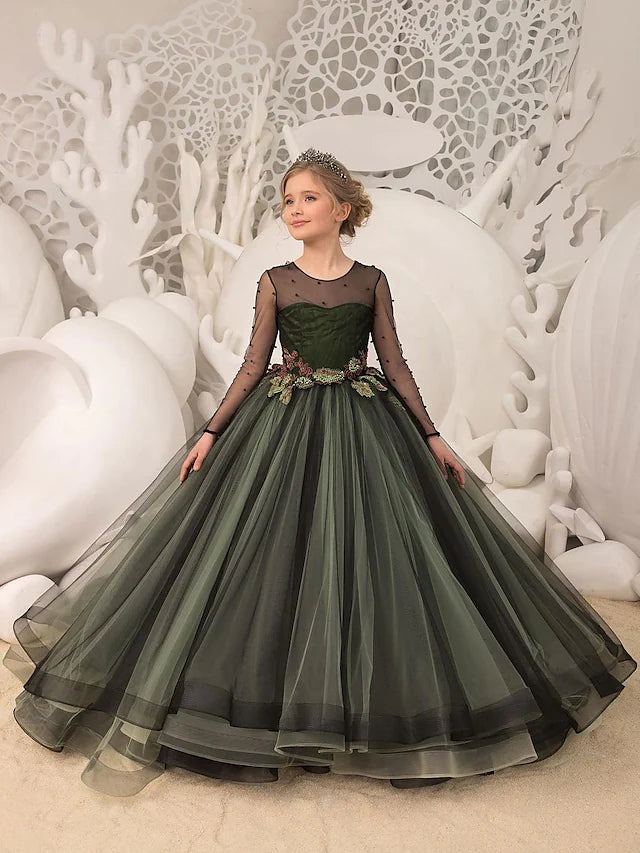 Flower girl wearing a floor-length tulle dress with long sleeves, jewel neck, and a sash ribbon.