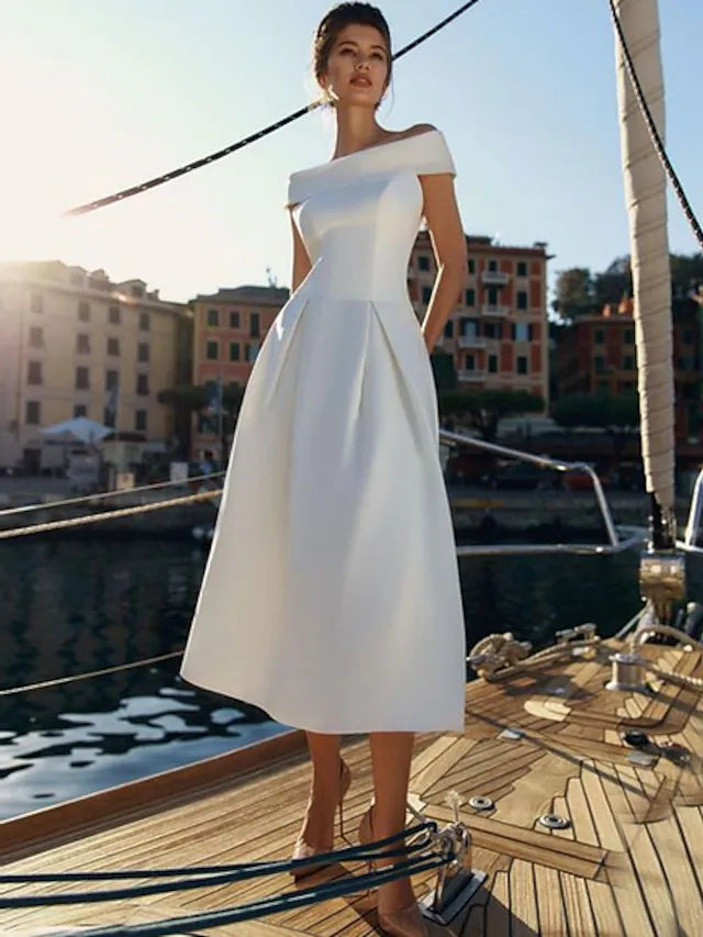 Woman posing in a chic A-line off-shoulder short sleeve satin cocktail dress.