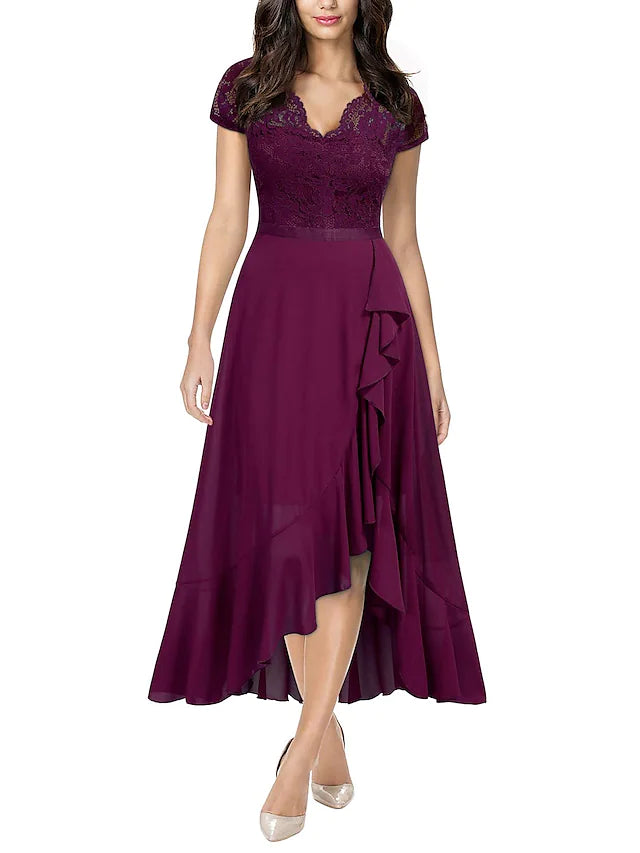 Close-up of the pleated bodice and lace insert on the black cocktail dress.