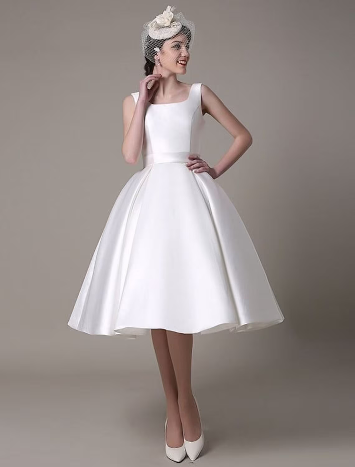 Elegant A-line satin cocktail dress with square neck and pleats.