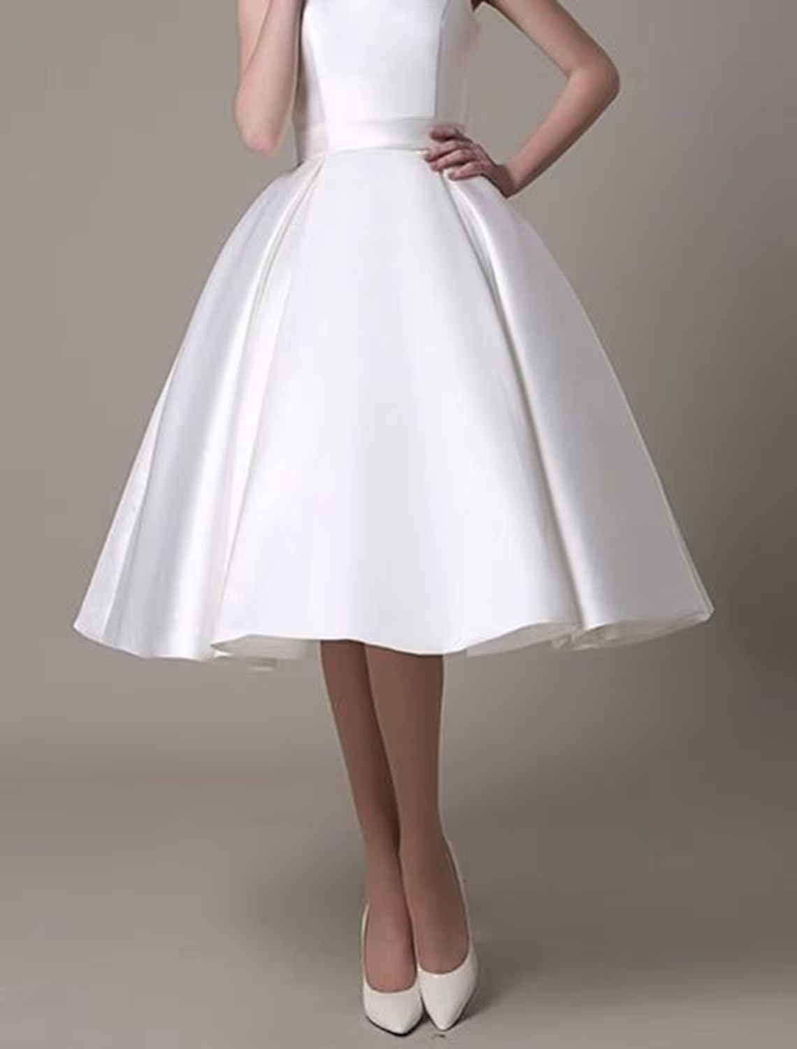 Close-up of the pleated satin fabric on the A-line dress.