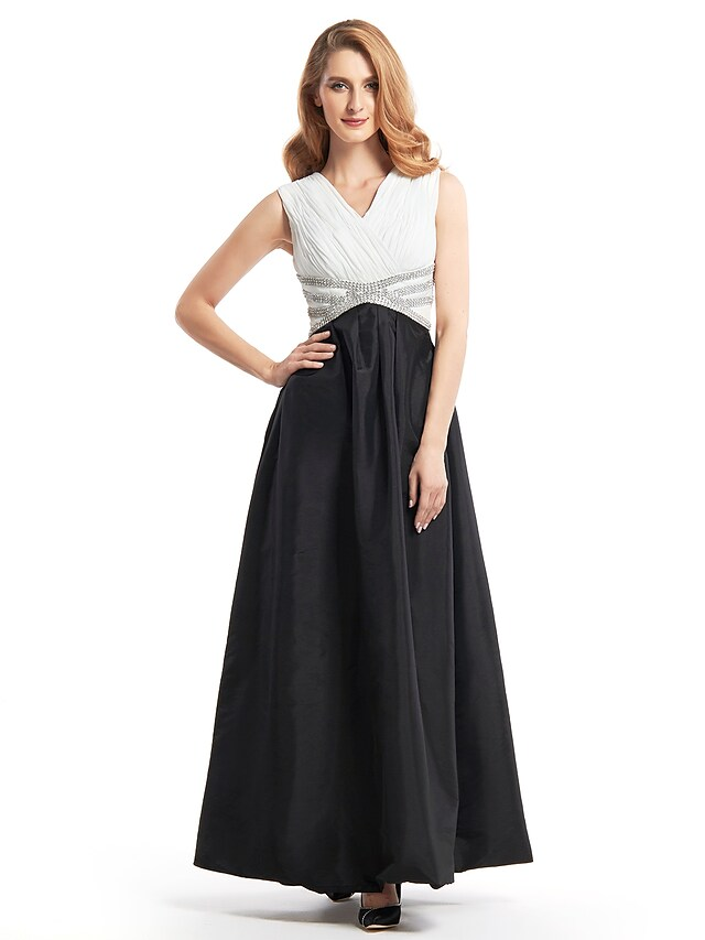 Woman wearing an A-line V-neck color block mother of the bride dress with criss-cross beading.