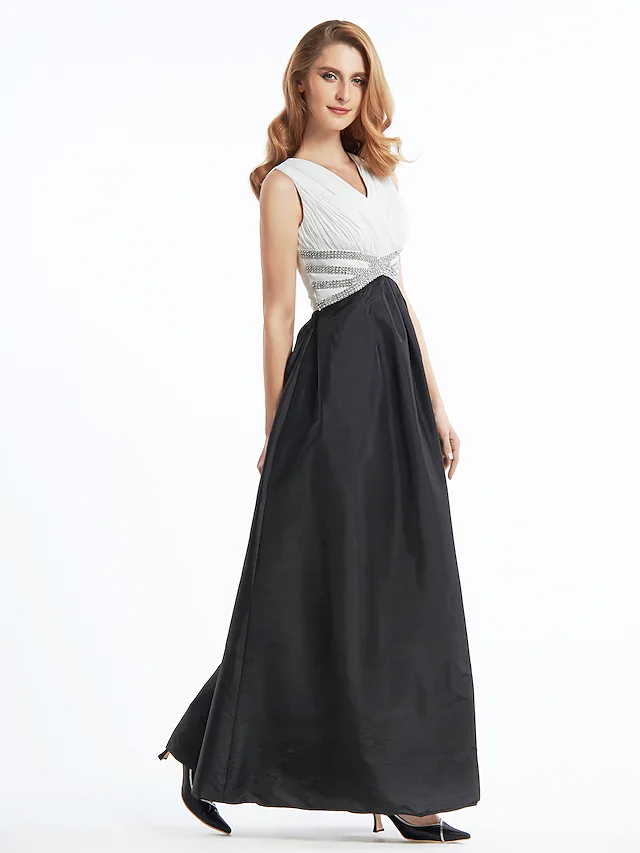 Side view of the sleeveless A-line color block dress with ankle length hem.