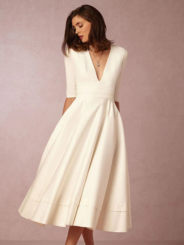 Front view of a chic A-line V-neck half sleeve pleated tea length party dress with pockets.