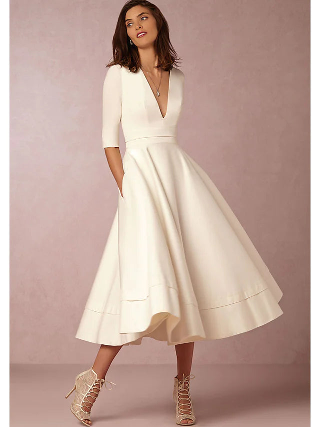 Side view of an A-line V-neck half sleeve pleated tea length dress, highlighting the silhouette.