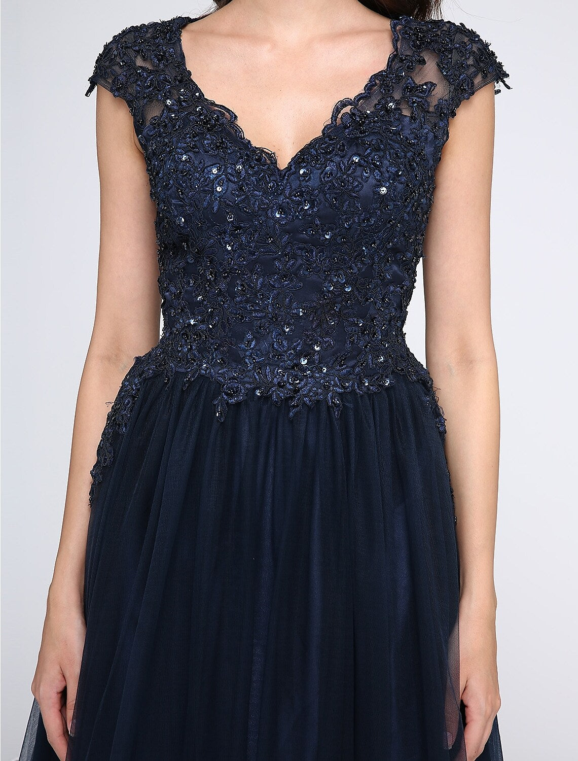 Back view of the sleeveless V-neck black prom dress.