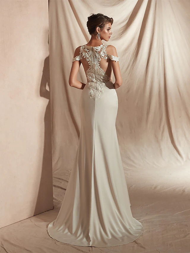 Close-up of appliques and illusion detail on wedding dress.