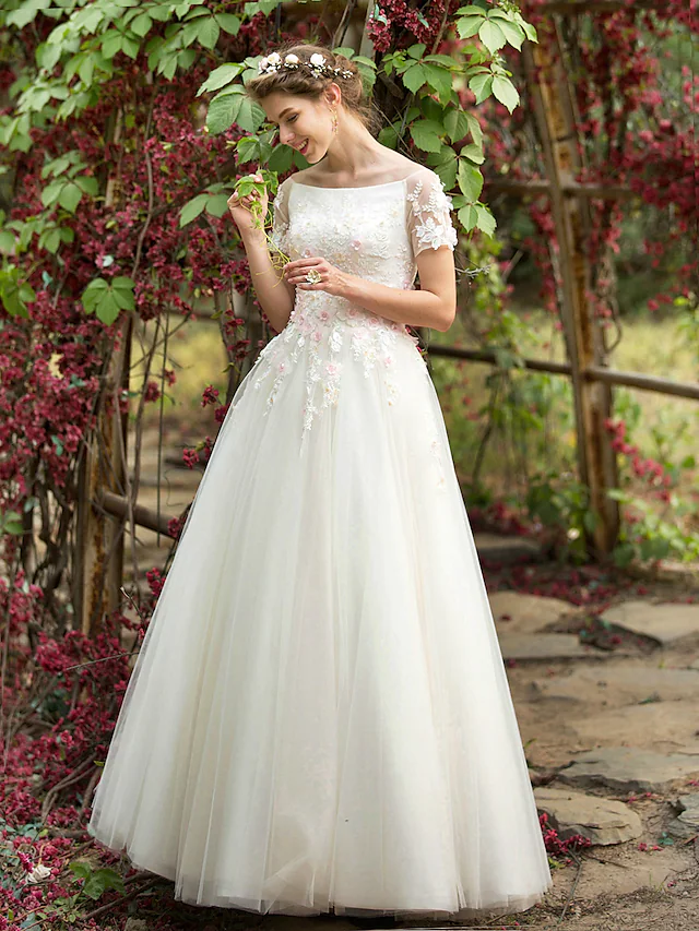 Elegant A-Line wedding dress with bateau neck and short sleeves.