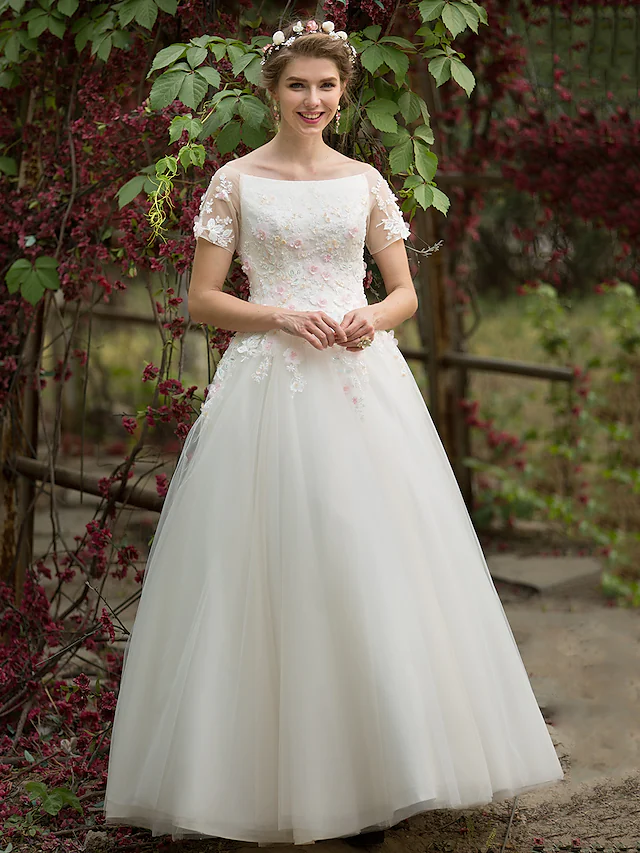 Close-up of the short sleeve and beading details on the wedding dress.