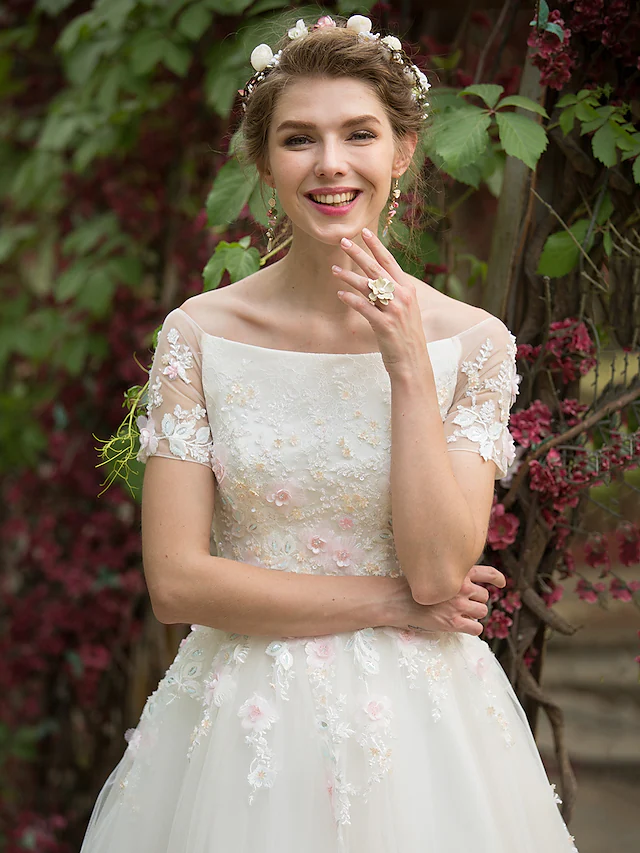 Bride wearing the elegant A-Line wedding dress with a flowing skirt.