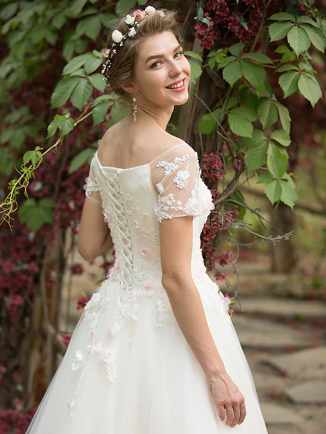 Detail of the floral appliques and tulle fabric on the wedding dress.