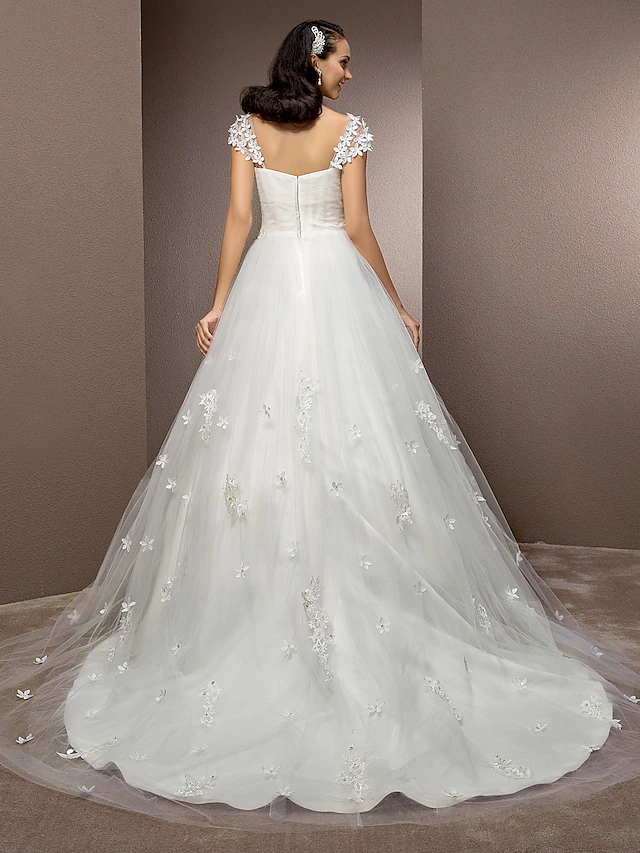 Side view of a bride wearing a square neck, short sleeve ball gown.