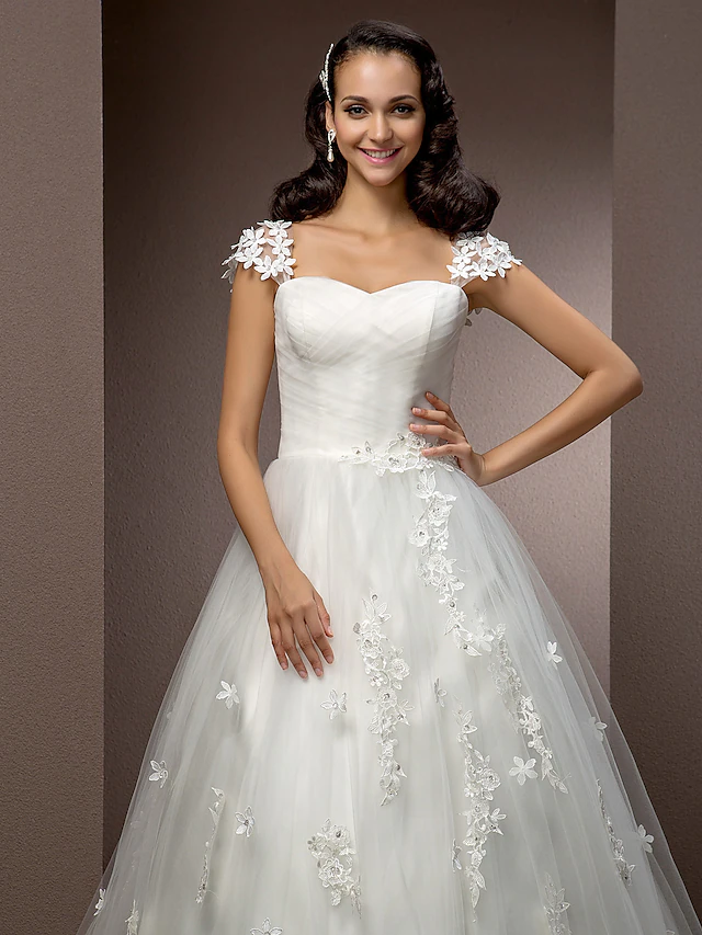 Full length view of a white ball gown wedding dress.