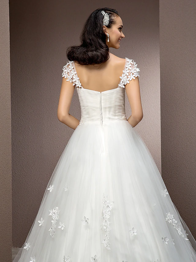 Detail of the square neckline and short sleeve on a bridal gown.