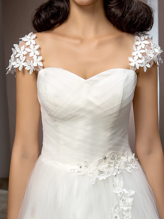 Flowing court train of a tulle wedding dress.