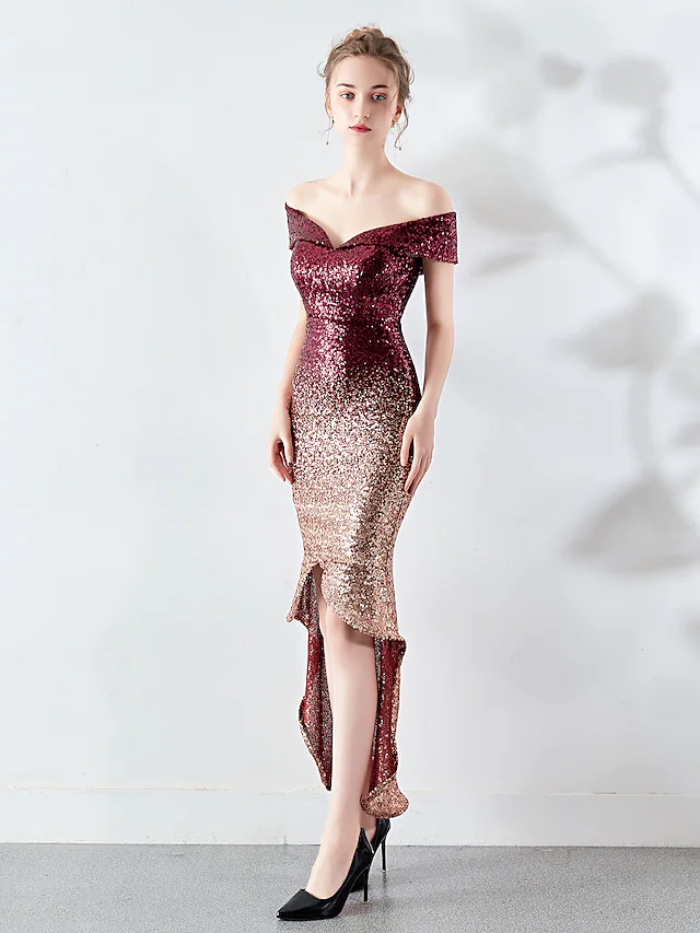 Back view of a woman in a shimmering sequined off-shoulder cocktail dress.