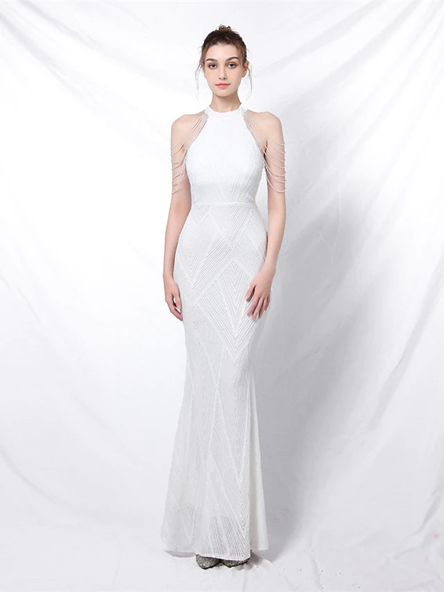 Model wearing a gold sequined mermaid prom dress with a halter neckline.
