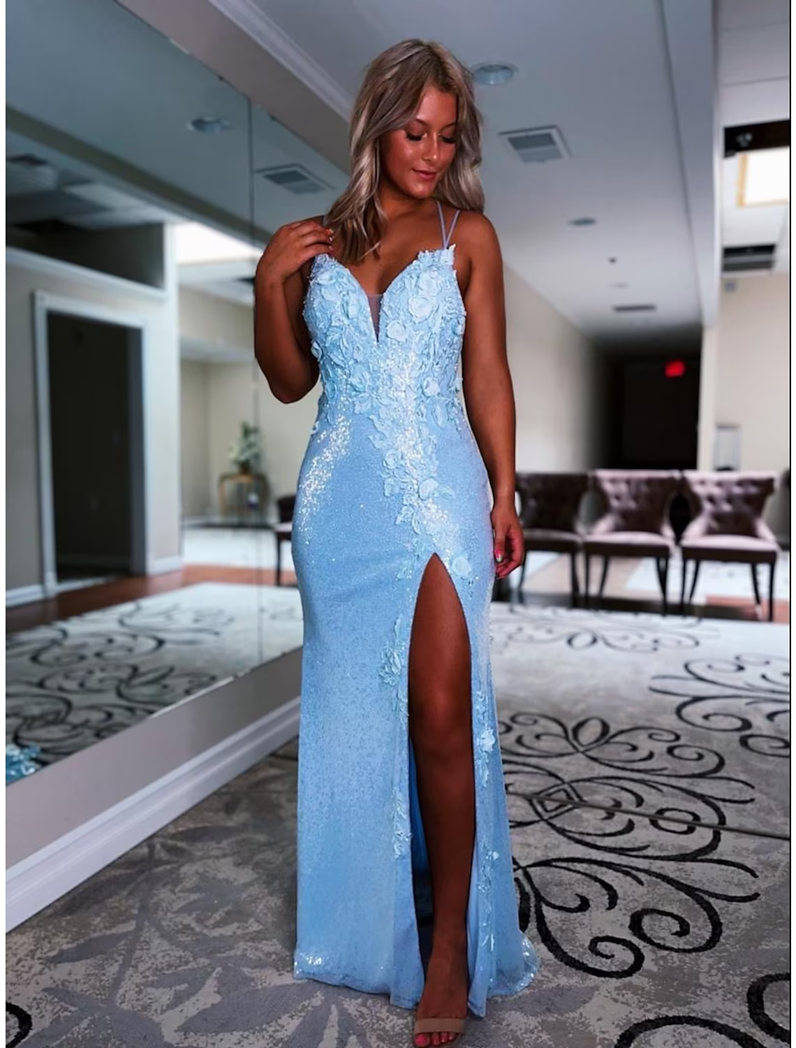 Dazzling sequined mermaid trumpet prom gown with V-neckline.