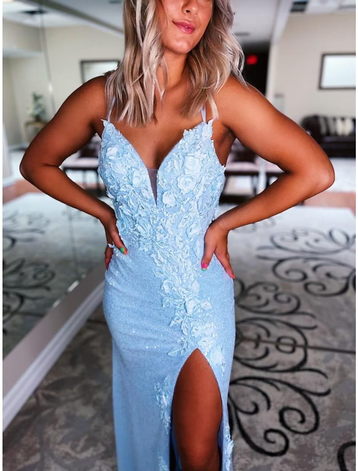 Back view of sequined mermaid prom dress featuring a backless design.