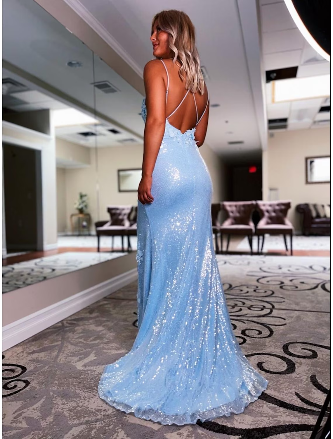 Elegant sequined prom gown with a graceful sweep train.