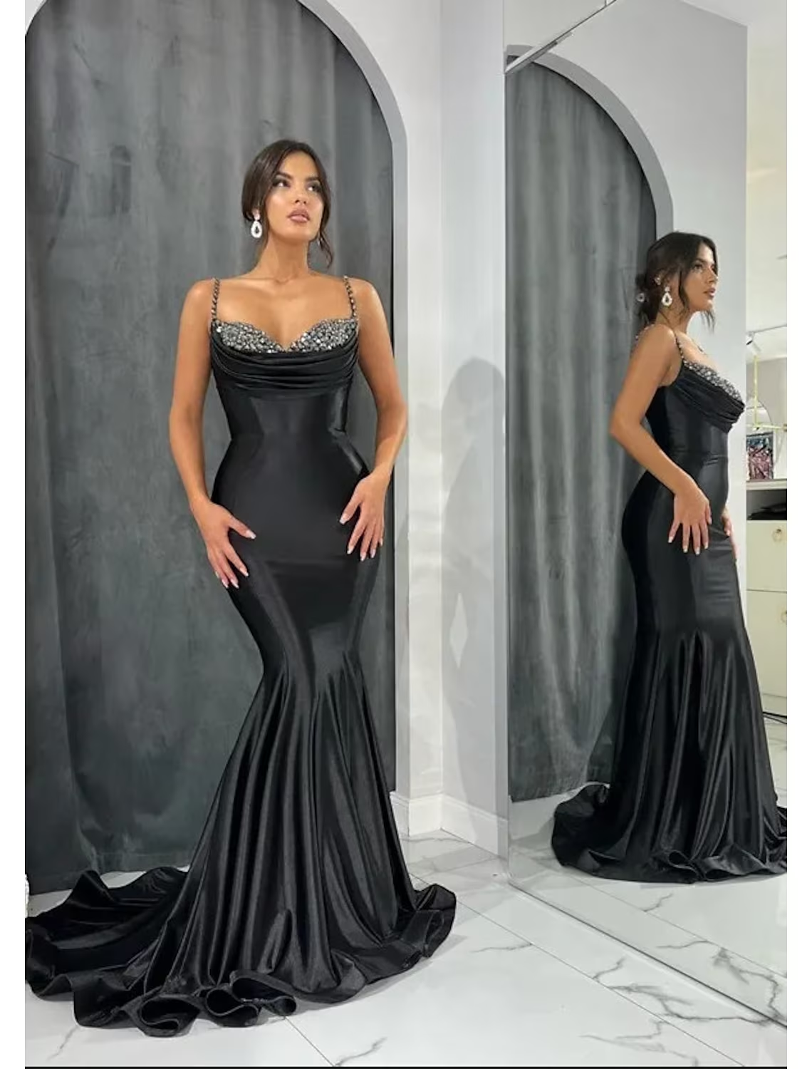 Model wearing a dazzling sweetheart mermaid trumpet evening gown with glitter crystals and an open back.