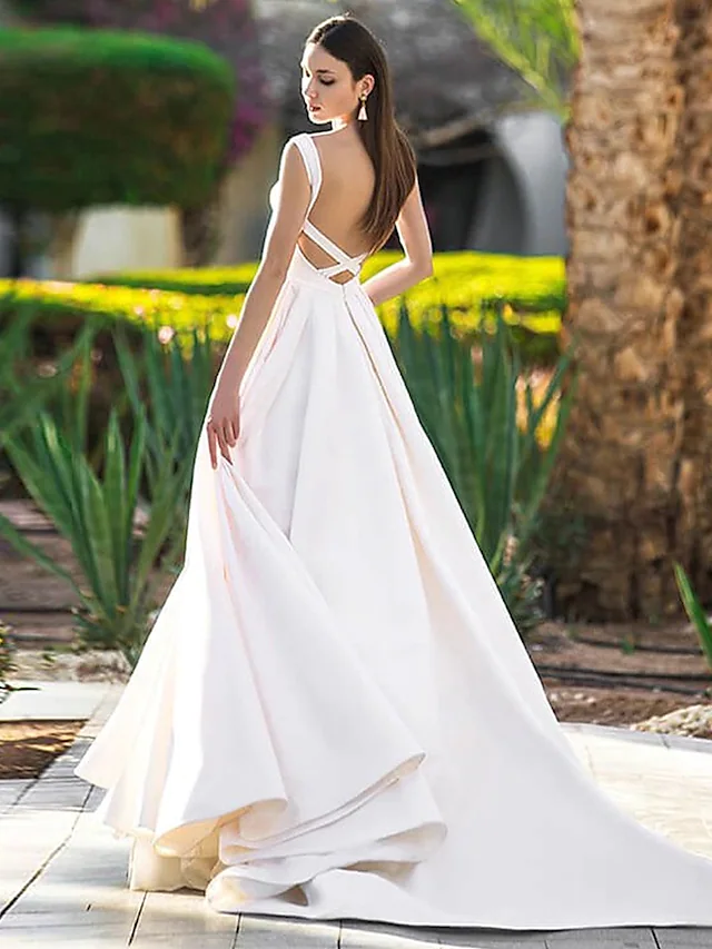 Elegant A-Line wedding dress with bateau neck, cap sleeves, and V-back with buttons.
