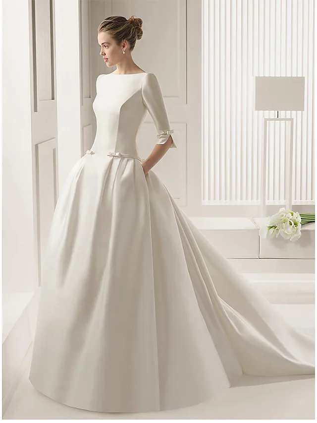 Elegant A-line wedding dress with bateau neckline and half sleeves.