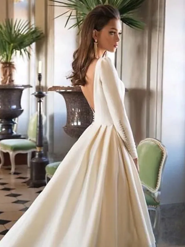 Close-up detail of the A-Line wedding dress fabric and bateau neckline.