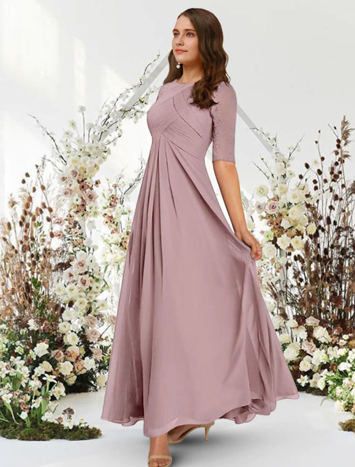 Side profile of the elegant A-line gown, showcasing pleats and flow.