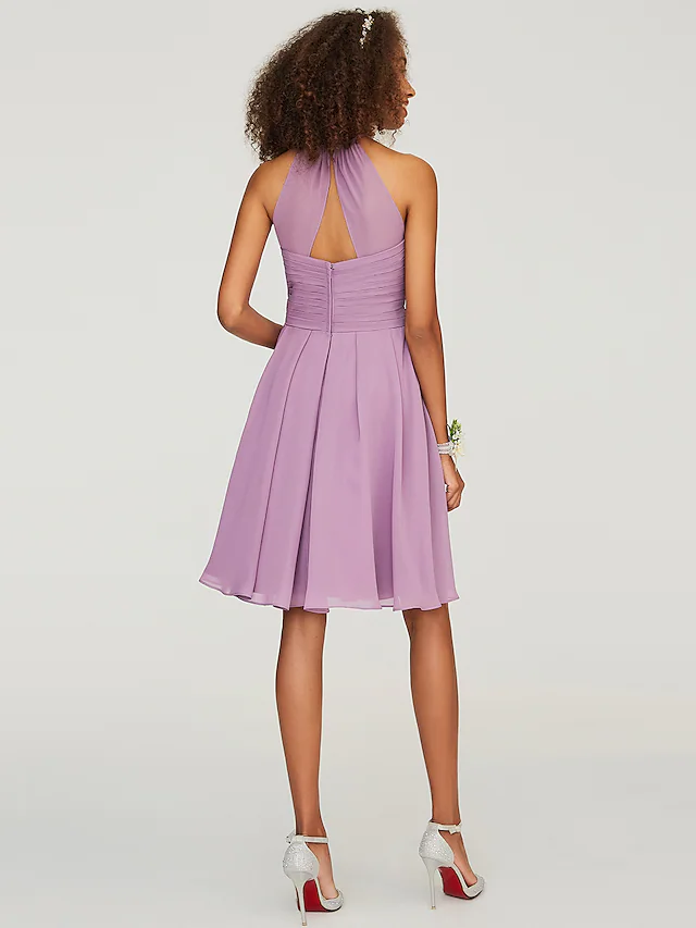 Flowy chiffon dress with a halter neck and delicate ruffles.