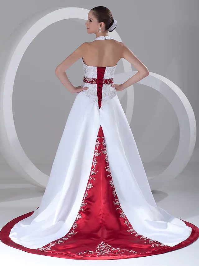 Back view of the wedding dress, highlighting the chapel train and straps.