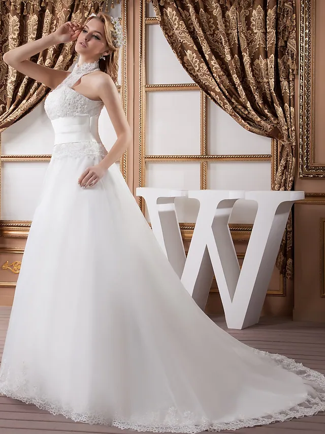 Close-up of ruched lace and beading appliques on wedding dress.