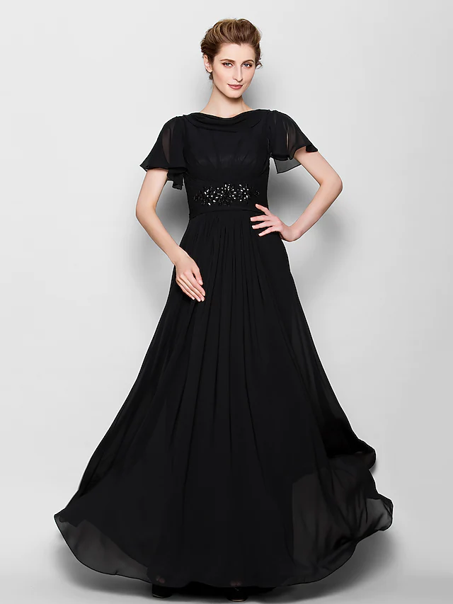 Close-up of the beaded detailing on the illusion bateau neckline of the formal gown.