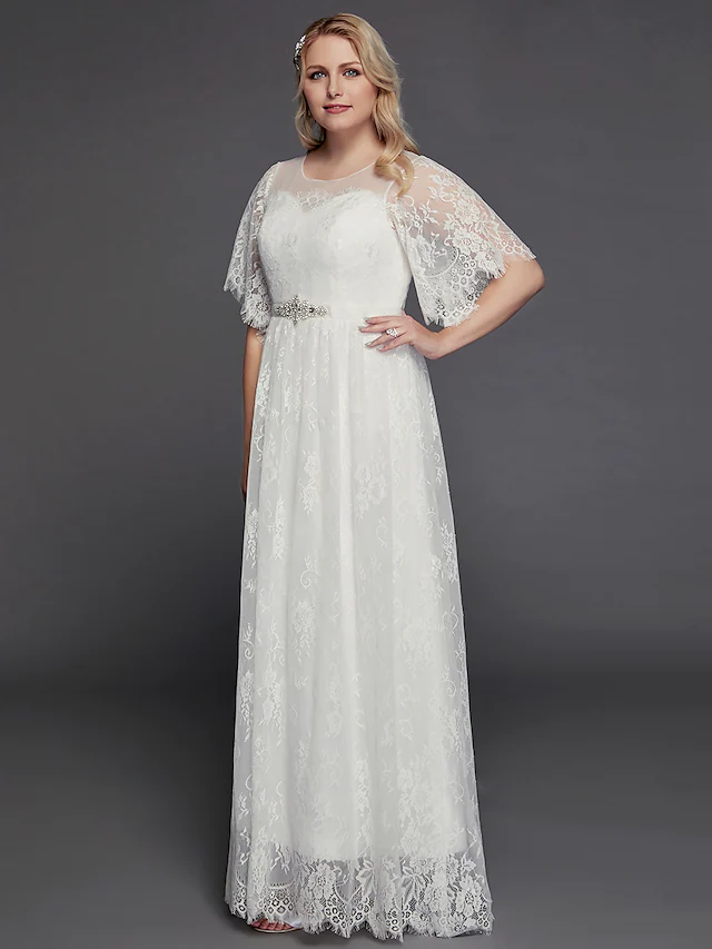Close-up of the illusion jewel neckline and half sleeves with intricate lace embellishments on the wedding dress.