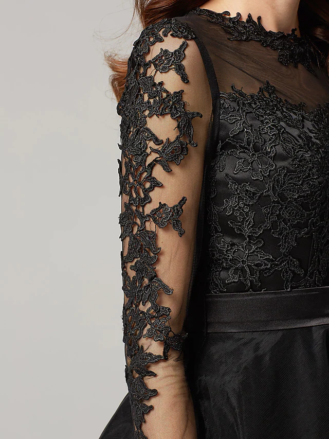 Close-up of the illusion neck and lace appliques on the dress.