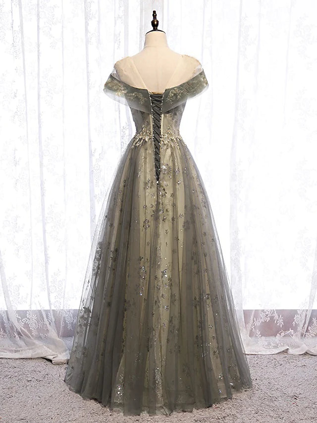 Side profile of the floor-length evening gown, highlighting the pleated skirt.
