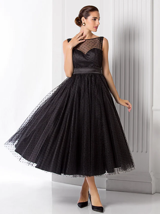 Close-up of the illusion neckline and intricate pattern print on the black tulle fabric.