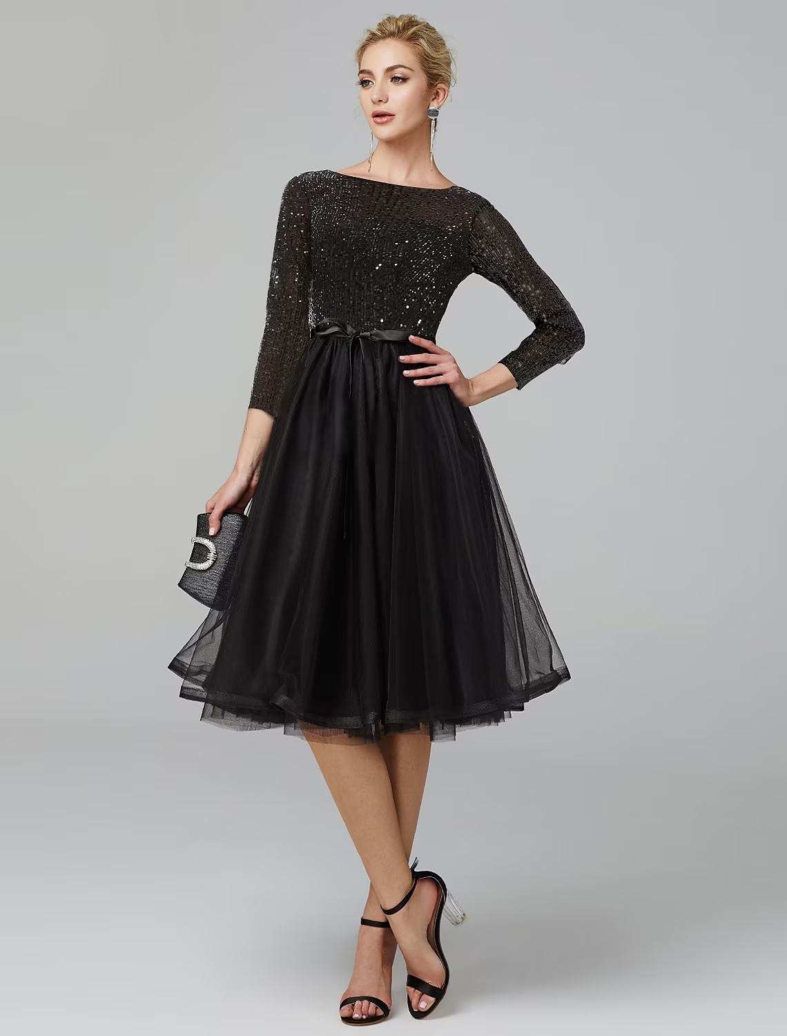 Side view of a model in a sequin tulle A-line cocktail dress.