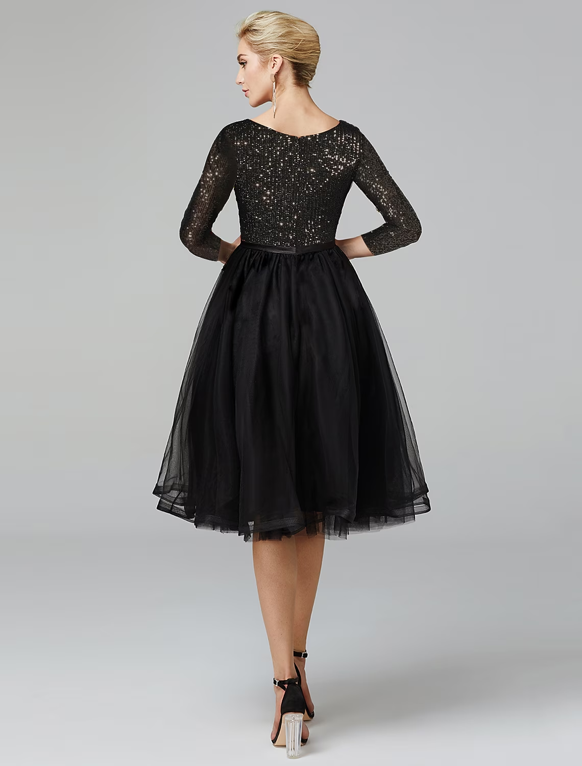 Close-up of the sequin embellished tulle fabric on the cocktail dress.