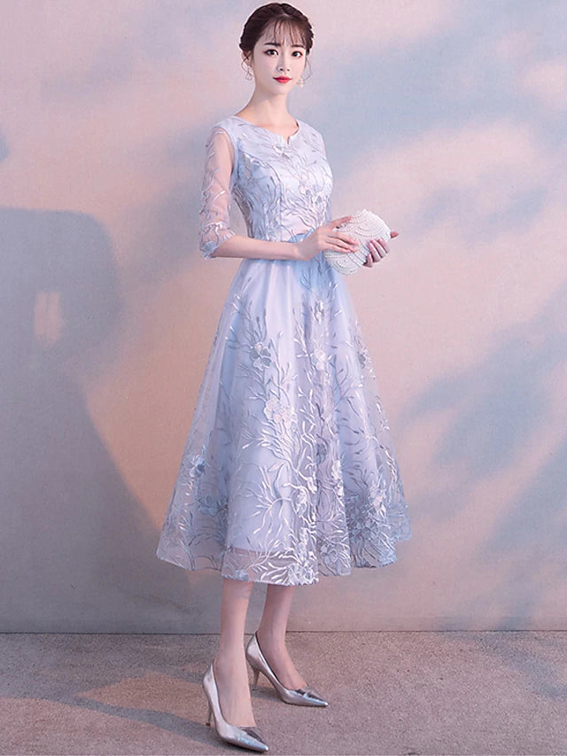 Elegant A-Line tea length dress with jewel neck and 3/4 lace sleeves.